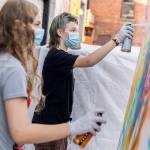 Nick Lawing, 13, right, and Kayak Pidgeon, 14, right, spray paint a canvas during Teen Night at the Schack Art Center on Sept. 18, 2025 in Everett, Washington. (Olivia Vanni / The Herald)