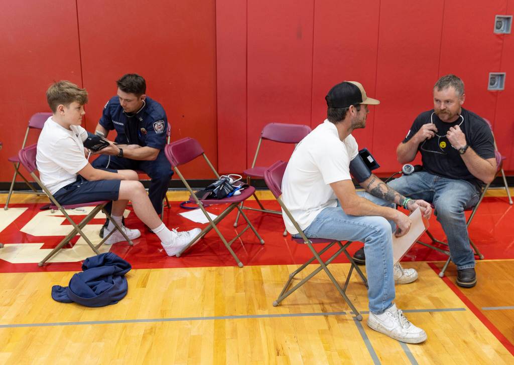 People get their blood pressure recorded during Stanwood High Schools EKG Youth Heart Screening event on Oct. 1, 2025 in Stanwood, Washington. (Olivia Vanni / The Herald)