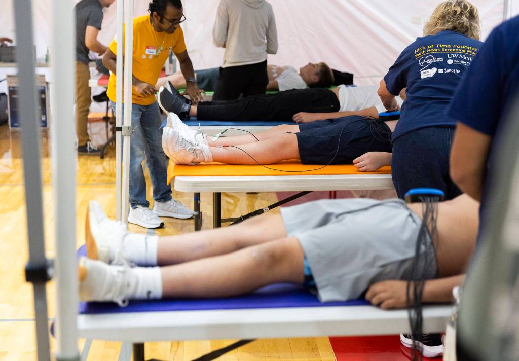 Students lie on tables while they get hooked up to EKG machines on Oct. 1, 2025 in Stanwood, Washington. (Olivia Vanni / The Herald)