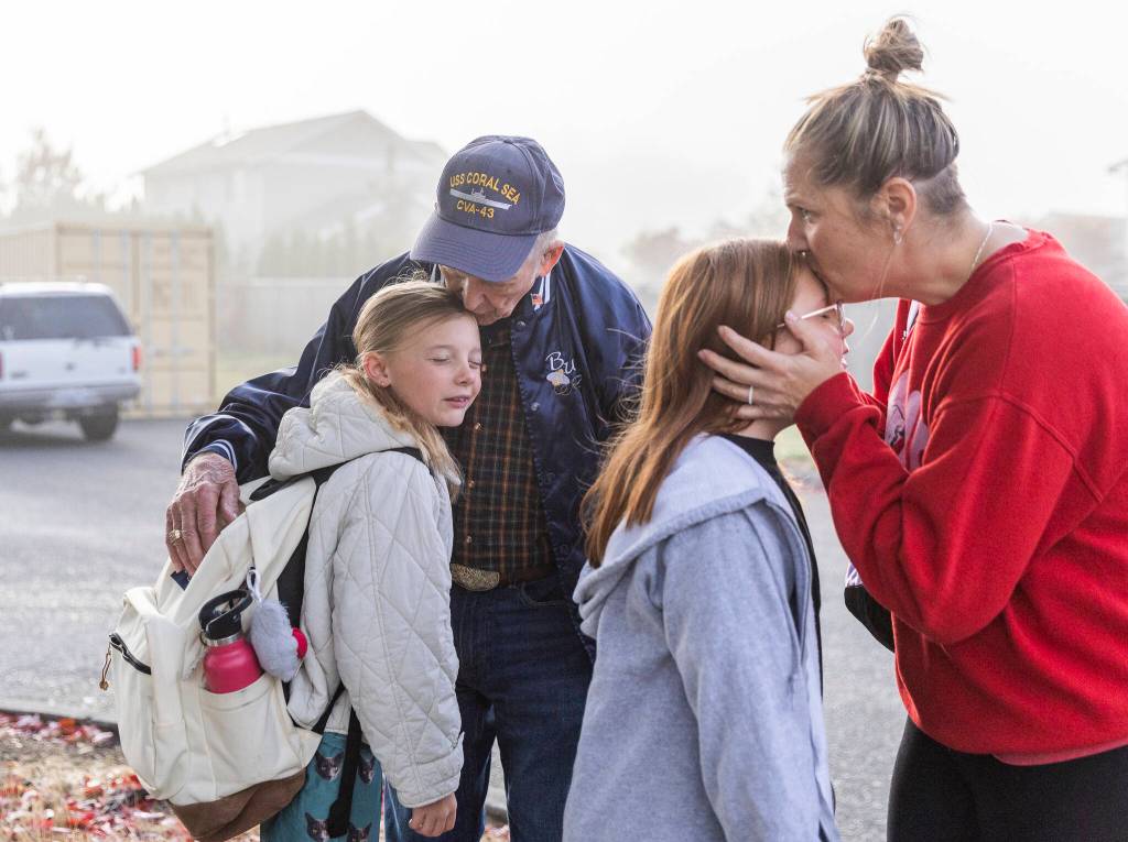 Grandpa Buzz hugs Indy goodbye while Teagan says goodbye to her mother Shannon Richards in Snohomish. (Olivia Vanni / The Herald)