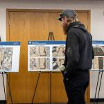 People looks at development plans for the Arlington Municipal Airport on Oct. 8, 2025 in Arlington, Washington. (Olivia Vanni / The Herald)