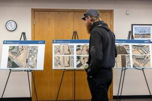 People looks at development plans for the Arlington Municipal Airport on Oct. 8, 2025 in Arlington, Washington. (Olivia Vanni / The Herald)
