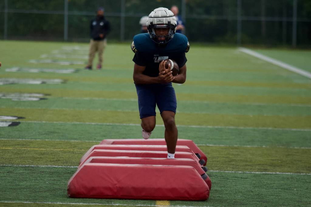 Glacier Peak senior Isaiah Owens carries the ball in a drill during the Grizzlies practice at Glacier Peak High School in Snohomish on Sept. 30, 2025. (Joe Pohoryles / The Herald)