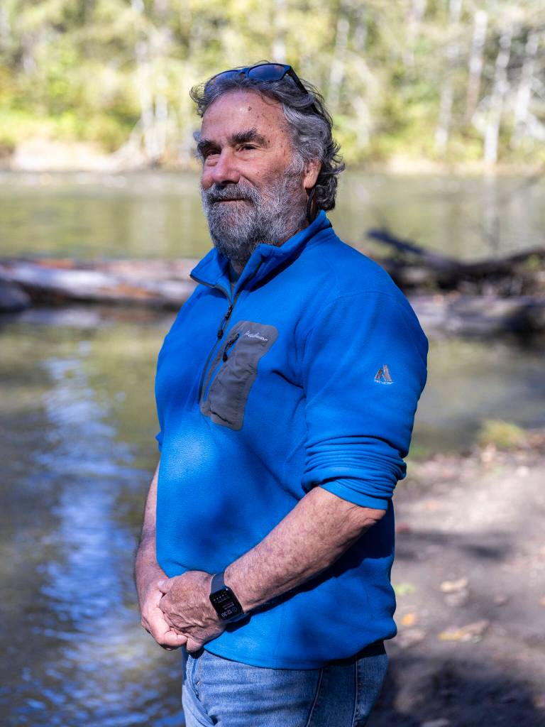 Greg Ruggerone, a salmon researcher, poses for a portrait along the Sultan River on Sept. 30, 2025 in Sultan, Washington. (Olivia Vanni / The Herald)