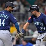 The Seattle Mariners' Cal Raleigh (29) is congratulated by Julio Rodriguez (44) after hitting a two-run home run against the San Diego Padres during the sixth inning at Petco Park on May 16, 2025, in San Diego. (Orlando Ramirez / Getty Images / Tribune News Services)