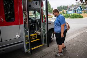 Doug Wennerberg boards the ParaTranist bus on Thursday, Sept. 1, 2022 in Everett, Washington. (Olivia Vanni / The Herald)
