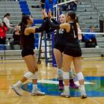 Archbishop Murphy's Ashley Fletcher (left), Emma Morgan-McAuliff (center) and Layla Miller celebrate after scoring a point in the Wildcats' 3-0 win against Shorewood at Shorewood High School on Oct. 2, 2025. (Joe Pohoryles / The Herald)