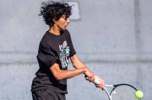 Arhan Sinha runs after the ball during the district championship doubles match on Thursday, Oct. 24, 2024 in Snohomish, Washington. (Olivia Vanni / The Herald)