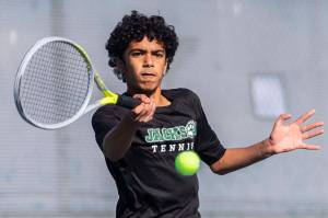 Rajveer Lahankar hits the ball during the district championship doubles match on Thursday, Oct. 24, 2024 in Snohomish, Washington. (Olivia Vanni / The Herald)