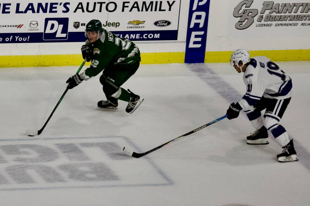 Silvertips forward Jesse Heslop (left) pushes through the neutral zone during Everetts 9-4 win against Victoria at Angel of the Winds Arena on Oct. 4, 2025. (Joe Pohoryles / The Herald)