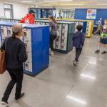 People walk through the Explorer Middle School locker rooms in their new athletics building on Oct. 7, 2025 in Everett, Washington. (Olivia Vanni / The Herald)