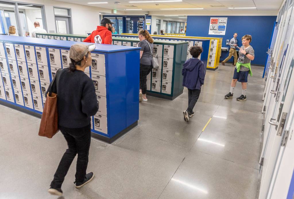 People walk through the Explorer Middle School locker rooms in their new athletics building on Oct. 7, 2025 in Everett, Washington. (Olivia Vanni / The Herald)