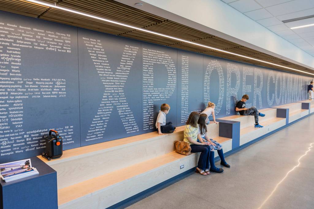 People sit on benches in the main hallway of Explorer Middle Schools new athletics building on Oct. 7, 2025 in Everett, Washington. (Olivia Vanni / The Herald)
