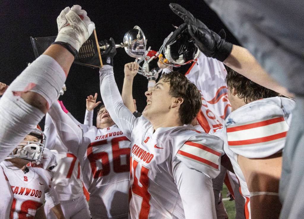 Stanwoods Michael Eagle holds up the Stilly Cup after beating Arlington on Oct. 10, 2025 in Arlington, Washington. (Olivia Vanni / The Herald)