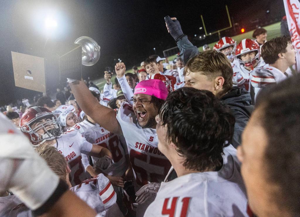 Stanwoods Memphys Ellis yells while holding the Stilly Cup after beating Arlington on Oct. 10, 2025 in Arlington, Washington. (Olivia Vanni / The Herald)