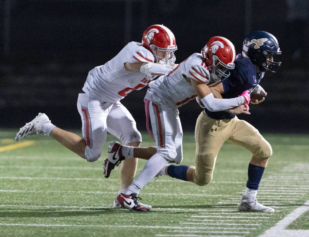 Arlingtons Linkin Currie is tackled out of bounds during the game against Stanwood on Oct. 10, 2025 in Arlington, Washington. (Olivia Vanni / The Herald)