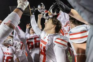 Stanwood’s Michael Eagle holds up the Stilly Cup after beating Arlington on Oct. 10, 2025 in Arlington, Washington. (Olivia Vanni / The Herald)