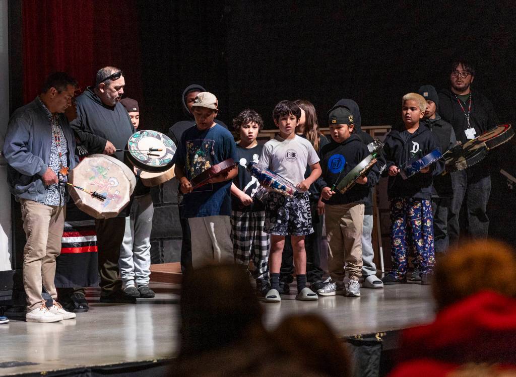 Students from Quil Ceda Tulalip Elementary drum at a mural reveal event at Marysville Pilchuck High School on Oct. 14, 2025 in Marysville, Washington. (Olivia Vanni / The Herald)