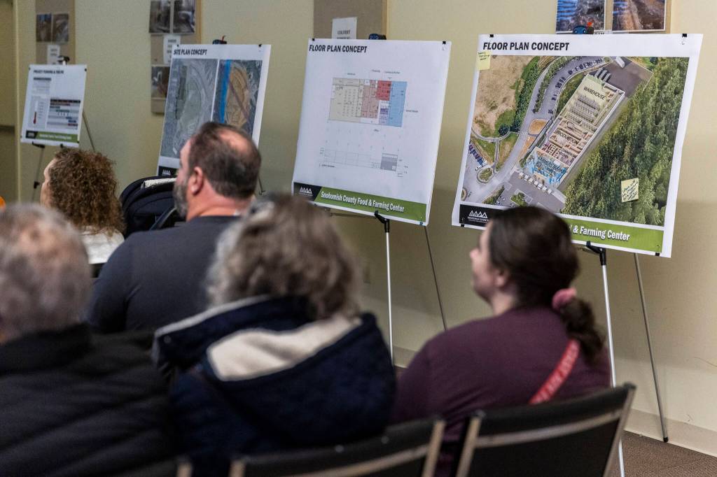 Concept art and informational board at an open house on Oct. 9, 2025 in Everett, Washington. (Olivia Vanni / The Herald)