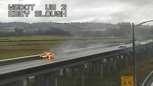 A vehicle burns Saturday morning on U.S. 2 on the trestle west of Highway 204. (Washington State Department of Transportation)