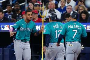Josh Naylor (12) of the Seattle Mariners celebrates with Julio Rodríguez (44) after hitting a two-run home run in the seventh inning against the Toronto Blue Jays during Game 2 of the American League Championship Series at Rogers Centre on Monday, October 13, 2025 in Toronto. (Daniel Shirey / Getty Images / The Athletic)
