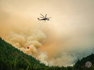 A helicopter conducts bucket drops over the Bear Gulch Fire. (Olympic National Forest)