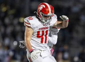 Stanwood’s Silas Turpin celebrates scoring a touchdown during the game against Arlington on Oct. 10, 2025 in Arlington, Washington. (Olivia Vanni / The Herald)