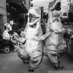 Jordan Gale / The New York Times
Two people in dinosaur costumes demonstrate against ICE in Portland, Ore., on Oct. 10. Images of anarchists clad in black gave the city a bad name in 2020. Now, demonstrators in Portland are poking fun at President Trumps apocalyptic talk with colorful animal suits.