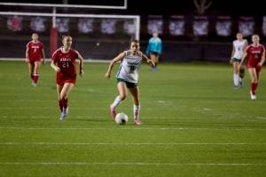 Edmonds-Woodway senior Jane Hanson (center) dribbles the ball upfield during the Warriors' 3-0 win against Archbishop Murphy at Terry Ennis Stadium on Oct. 16, 2025. (Joe Pohoryles / The Herald)