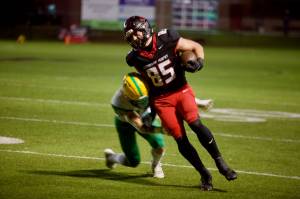 Archbishop Murphy senior Jack Sievers absorbs contact on a long reception during the Wildcats' 56-0 win against Lynden at Terry Ennis Stadium on Oct. 17, 2025. (Joe Pohoryles / The Herald)