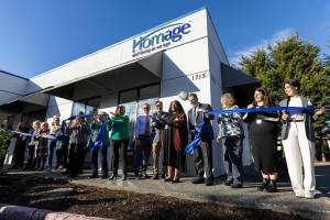 Homage CEO Jay Kang helps cut the ribbon outside of Homage’s new location on Oct. 21, 2025 in Everett, Washington. (Olivia Vanni / The Herald)