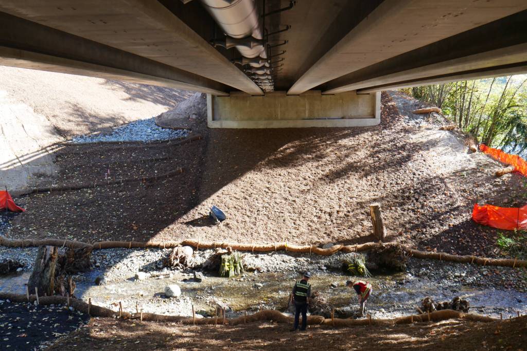 Crews work on landscaping final touches underneath the new Jordan Creek Bridge on Tuesday. The project is expected to finish middle of November. (Provided photo)