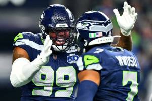 Uchenna Nwosu (7) and Leonard Williams (99) of the Seattle Seahawks celebrate during a game against the Houston Texans at Lumen Field on October 20, 2025 in Seattle, Washington. (Photo by Jane Gershovich / Getty Images / The Athletic)