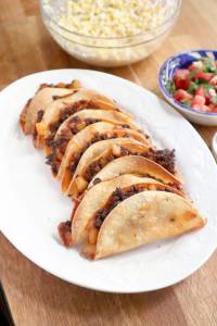 These crispy, cheesy chorizo and potato tacos are baked in the oven to achieve an extra crunch. (Post-Gazette)