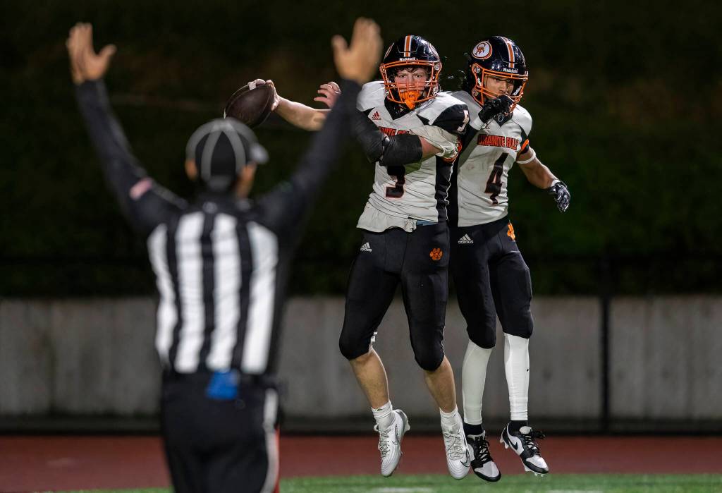 Granite Falls Beau Everson celebrates his touchdown with teammate Dwayne Pocknett during the game against Cedar Park Christian on Oct. 24, 2025 in Kirkland, Washington. (Olivia Vanni / The Herald)