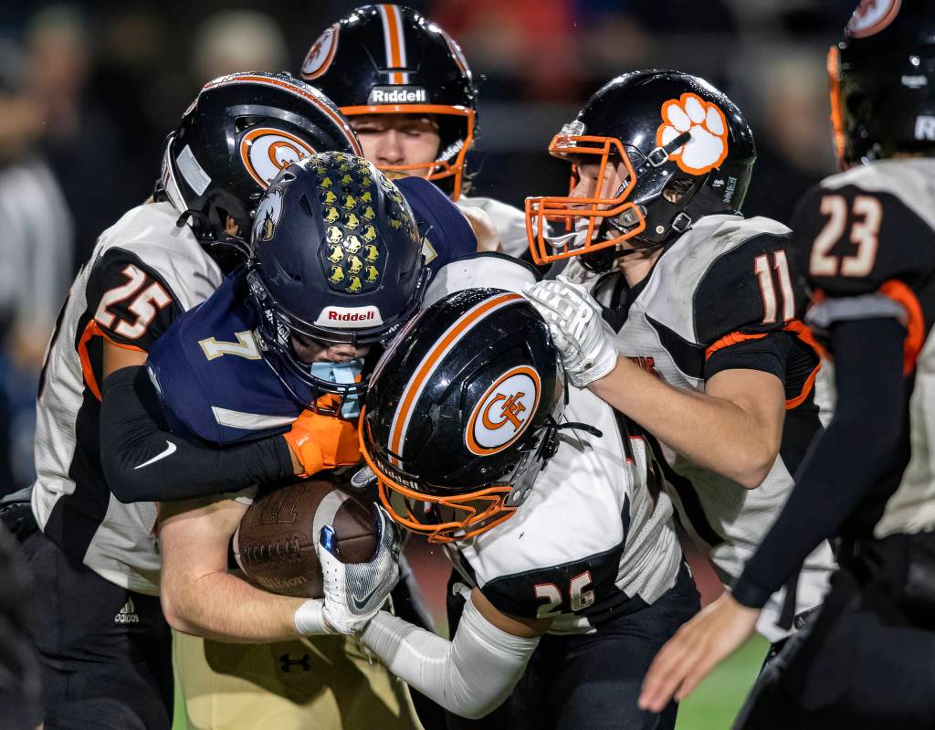 Granite Falls Angel Hernandez and Blake Hudson tackle Cedar Park Christians Lincoln Meyers during the game on Oct. 24, 2025 in Kirkland, Washington. (Olivia Vanni / The Herald)