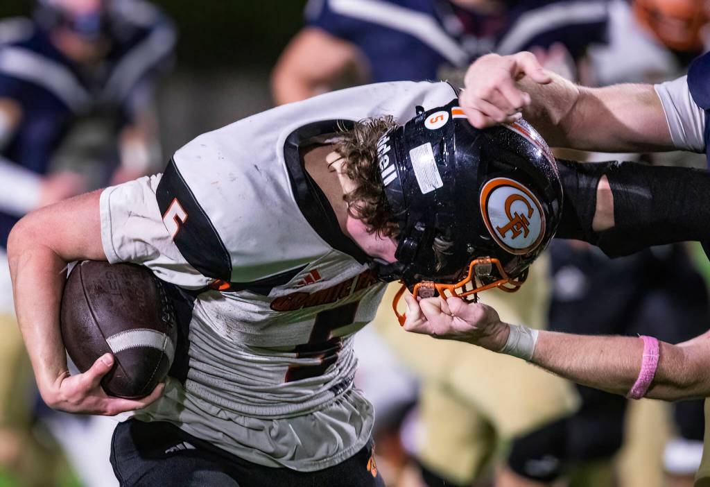 Granite Falls Beau Everson is grabbed by his helmet during the game against Cedar Park Christian on Oct. 24, 2025 in Kirkland, Washington. (Olivia Vanni / The Herald)