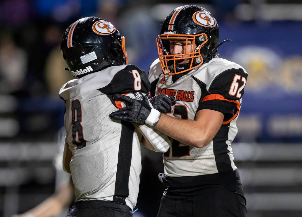 Granite Falls Drake Smith celebrates his touchdown with teammate Brayden Carlisle during the game against Cedar Park Christian on Oct. 24, 2025 in Kirkland, Washington. (Olivia Vanni / The Herald)