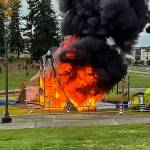 Everett firefighters arrived at Wiggums Hollow Park on Monday morning to find the equipment was fully engulfed in flames. (Derek Telford / The Herald)