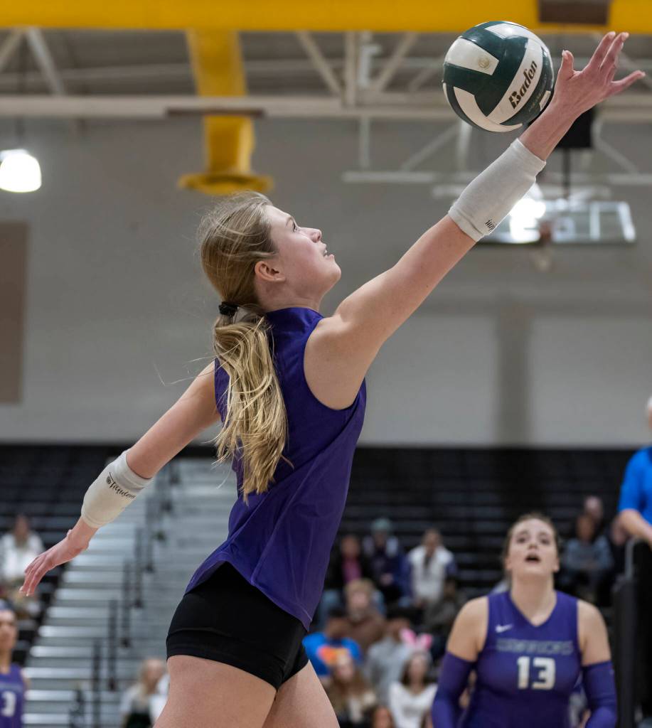 Edmonds-Woodways Eva Belova reaches up to tip the ball over the net during the game against Lynnwood on Oct. 29, 2025 in Edmonds, Washington. (Olivia Vanni / The Herald)