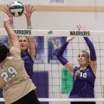 Lynnwoods Makena Kaleo spikes the ball over the net while Edmonds-Woodways Eva Belova and Raina Wilson jump up to block during the game on Oct. 29, 2025 in Edmonds, Washington. (Olivia Vanni / The Herald)