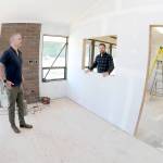 Keith Thorpe/Peninsula Daily News
Trevor Sly, operations manager of Olympic Hiking Co., left, and Tommy Farris, company owner and general manager, discuss relocating their business from The Wharf on the Port Angeles Waterfront to a new office on West Marine Drive.