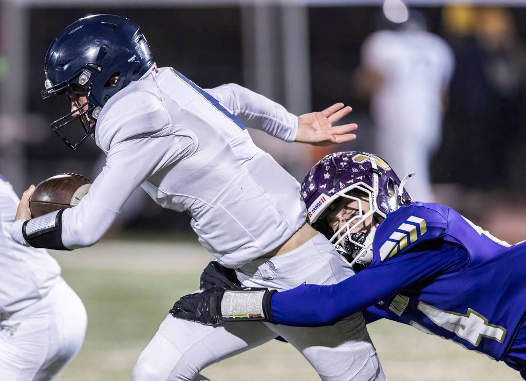 Arlingtons Kaleb Bartlett-Wood is tackled by Lake Stevens Dylan Phinney is tackled during the game on Oct. 31, 2025 in Lake Stevens, Washington. (Olivia Vanni / The Herald)