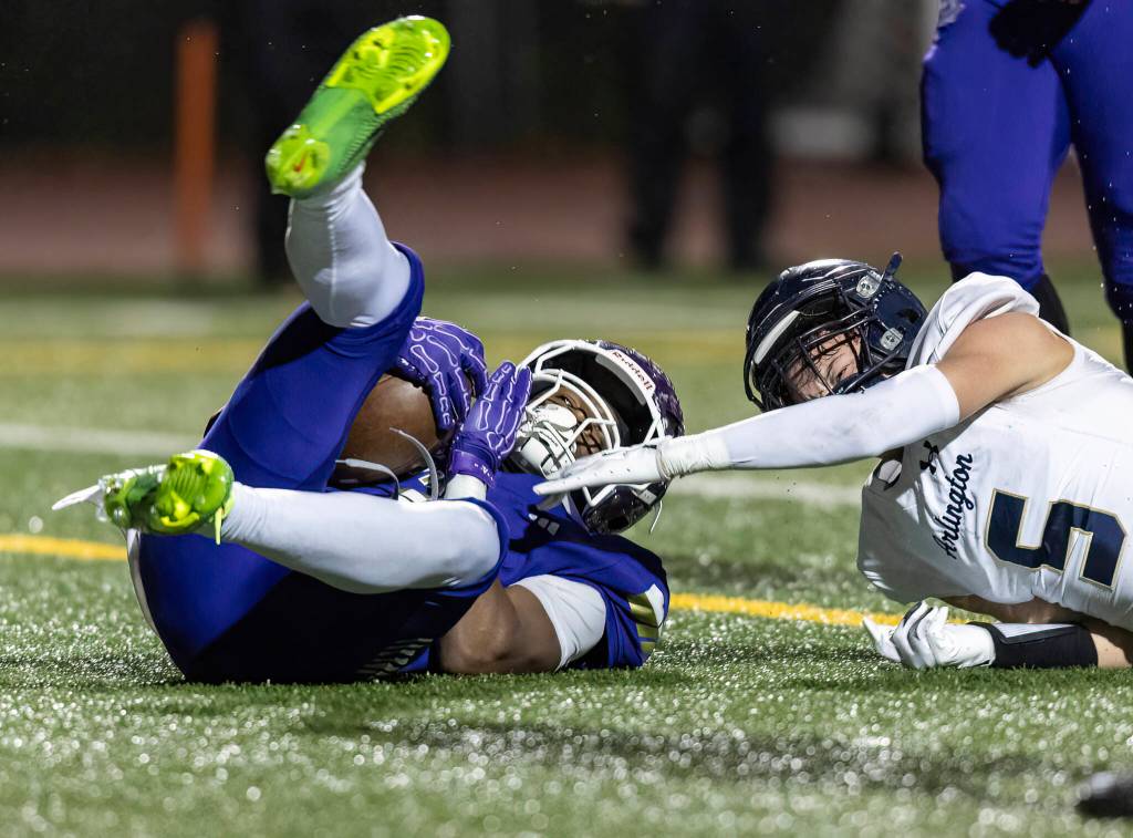 Lake Stevens Jayvian Ferrell rolls into the end zone for a touchdown during the game against Arlington on Oct. 31, 2025 in Lake Stevens, Washington. (Olivia Vanni / The Herald)