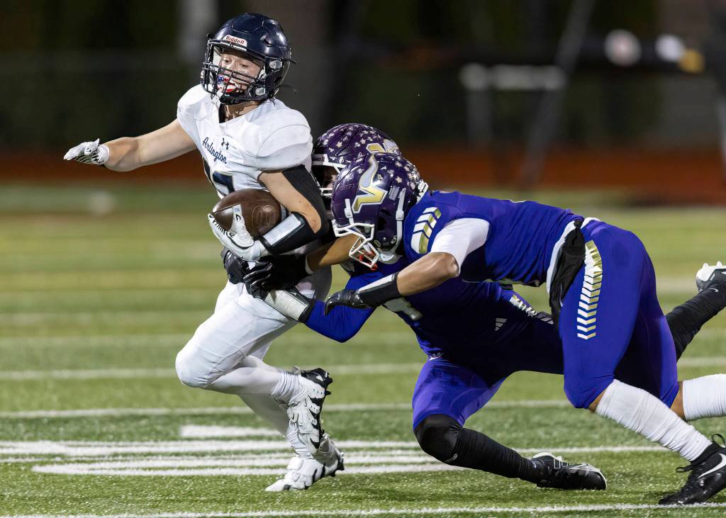 Arlingtons Jace Graham is tackled during the game against Lake Stevens on Oct. 31, 2025 in Lake Stevens, Washington. (Olivia Vanni / The Herald)