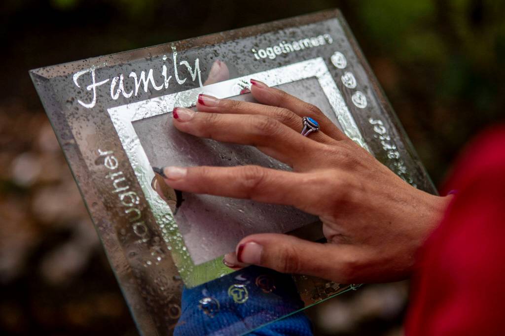 Gerry Davis holds an empty picture frame, which she intended to put a photo of her sister Mary at Hillcrest Park in Mount Vernon, Washington on Wednesday, May 29, 2024. (Annie Barker / The Herald)