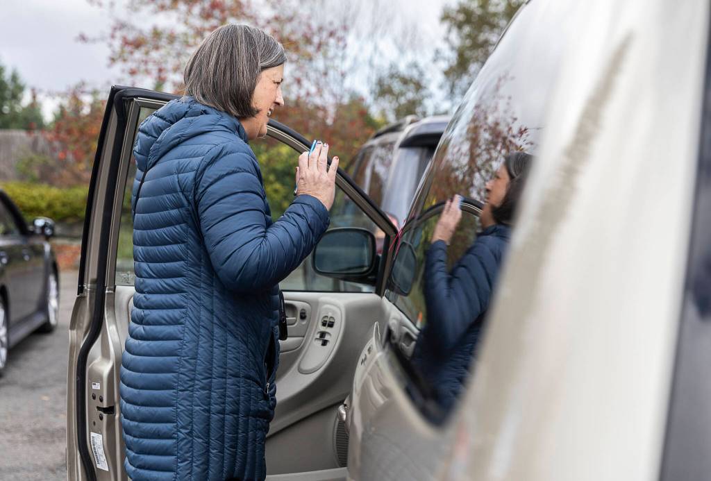 Sarah Zabel does customer intake at the Lynnwood Food Bank on Oct. 29 in Lynnwood. (Olivia Vanni / The Herald)