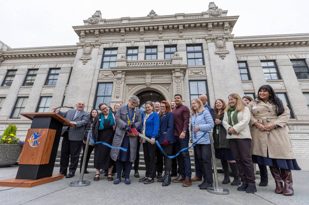 Everett High School Principal Kelly Shepard along with local politicians and community members cut a ceremonial ribbon outside of Everett High School to celebrate the opening of the new Student Health Clinic on Oct. 30, 2025 in Everett, Washington. (Olivia Vanni / The Herald)
