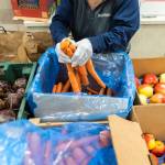 Fresh produce is put in bags at the Mukilteo Food Bank on Monday, Nov. 25, 2024 in Mukilteo, Washington. (Olivia Vanni / The Herald)