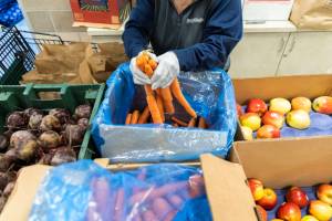 Fresh produce is put in bags at the Mukilteo Food Bank on Monday, Nov. 25, 2024 in Mukilteo, Washington. (Olivia Vanni / The Herald)